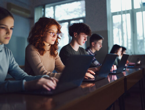 High school students e-learning over computers in the classroom.