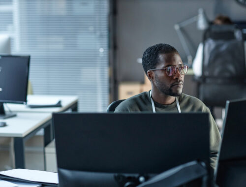Portrait of Black young man wearing glasses as IT